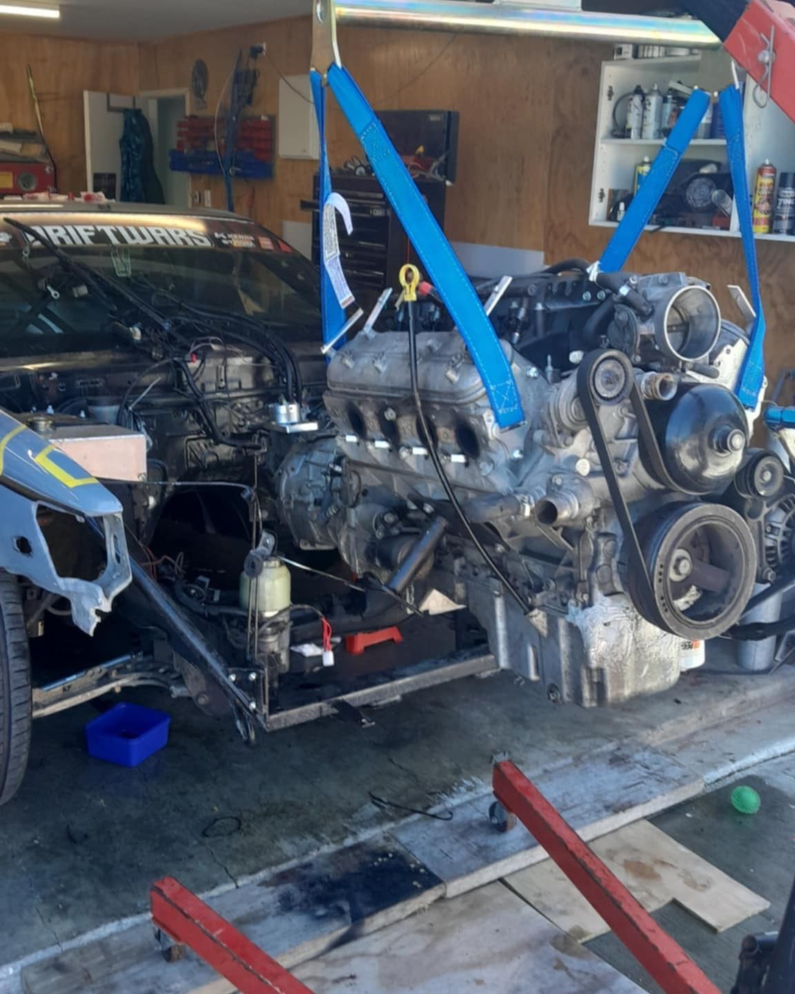 CamGoDrift engine is being removed from a car in a garage