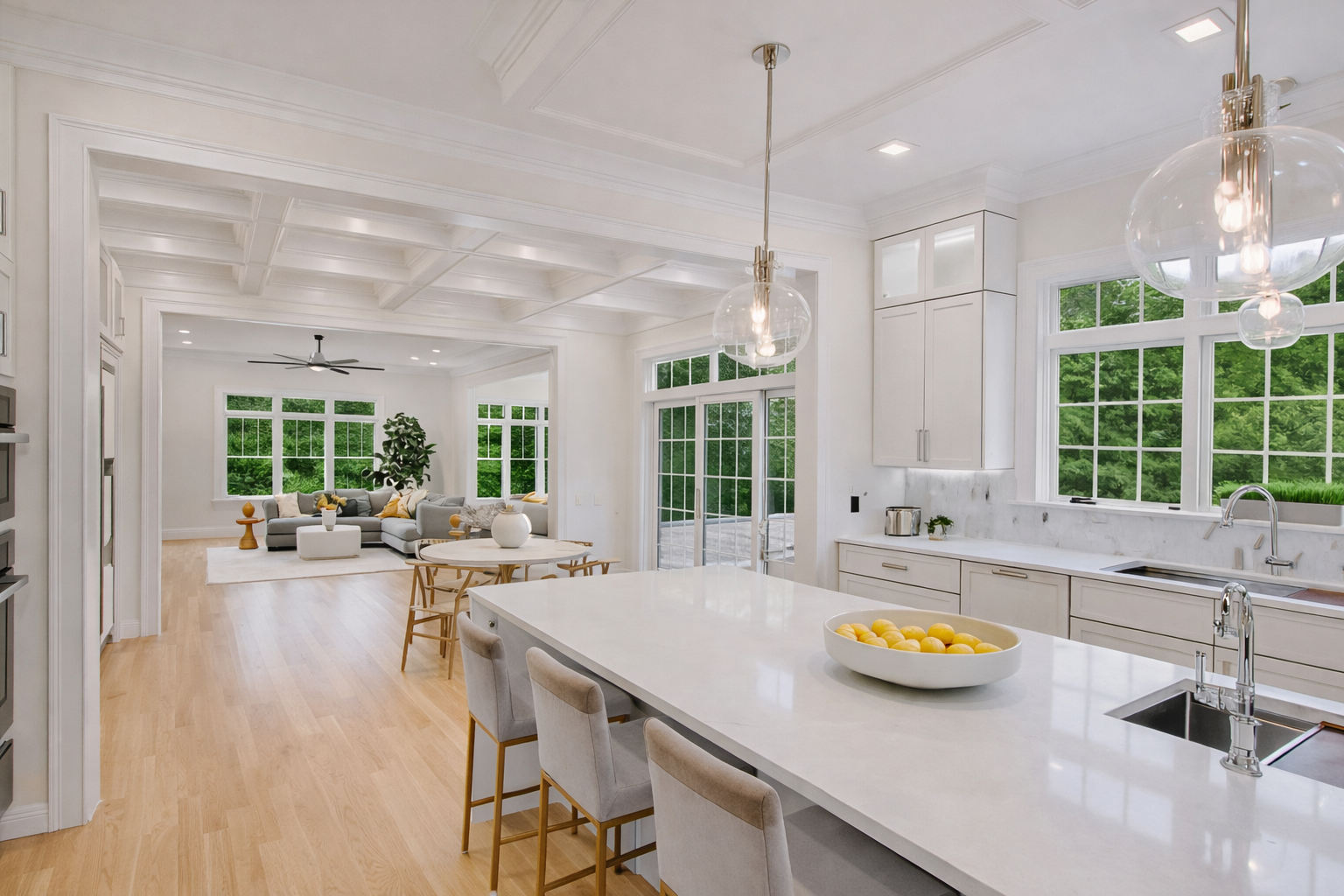 A kitchen with white cabinets , hardwood floors , and stainless steel appliances.