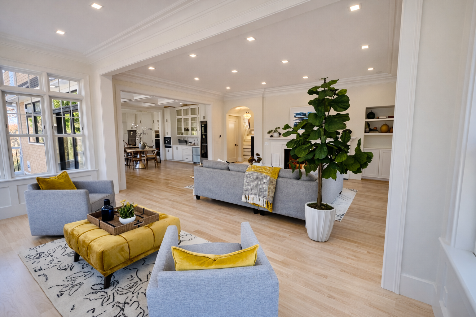 A living room with a couch , chairs , and a coffee table.
