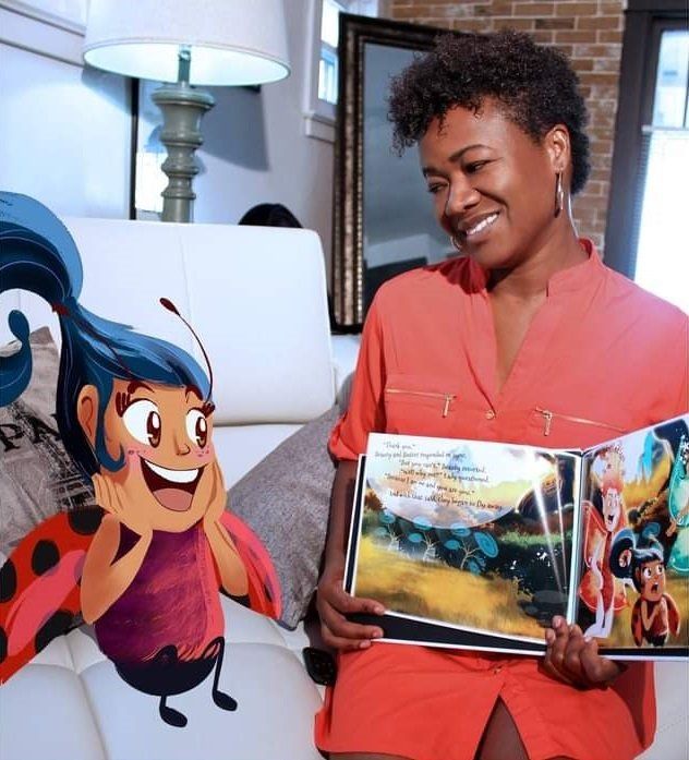 A ladybug is sitting next to a woman holding a book