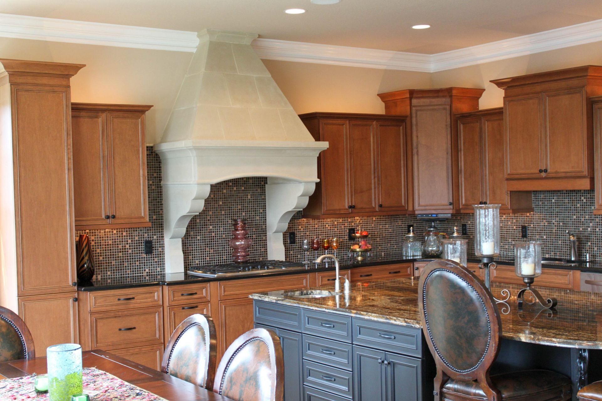 Modern kitchen with wooden cabinets, granite counters, and a large white range hood