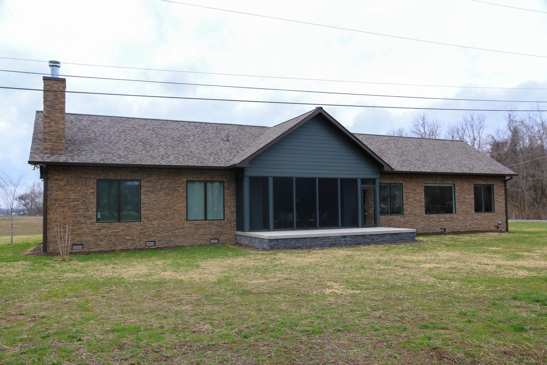 Single-story brick house with a covered front porch and grassy yard