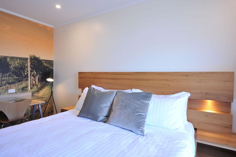 Renovated motel room with clean linens and natural light