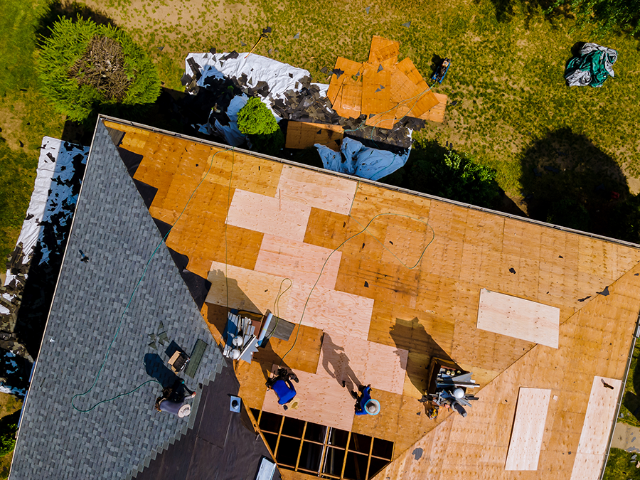 An aerial view of a roof being installed on a house.