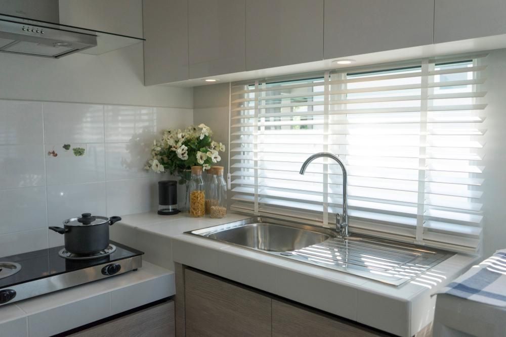 A Kitchen With A Pot On The Stove And A Sink — Outdoor Blinds In Berkeley Vale, NSW