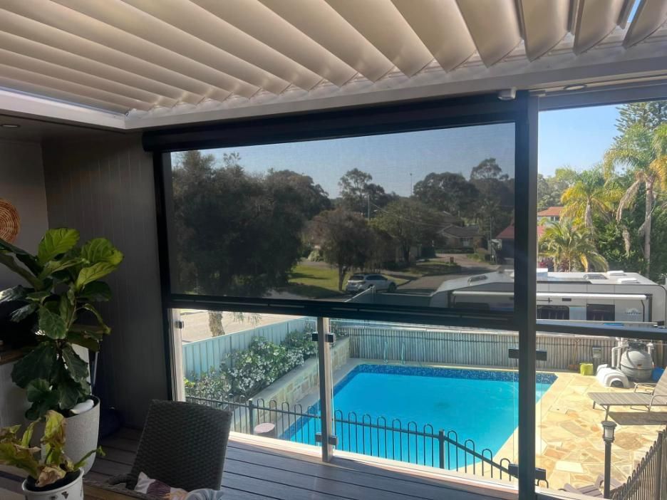 A Motorised Roller Blind With A Pool In The Background— Outdoor Blinds In Berkeley Vale, NSW