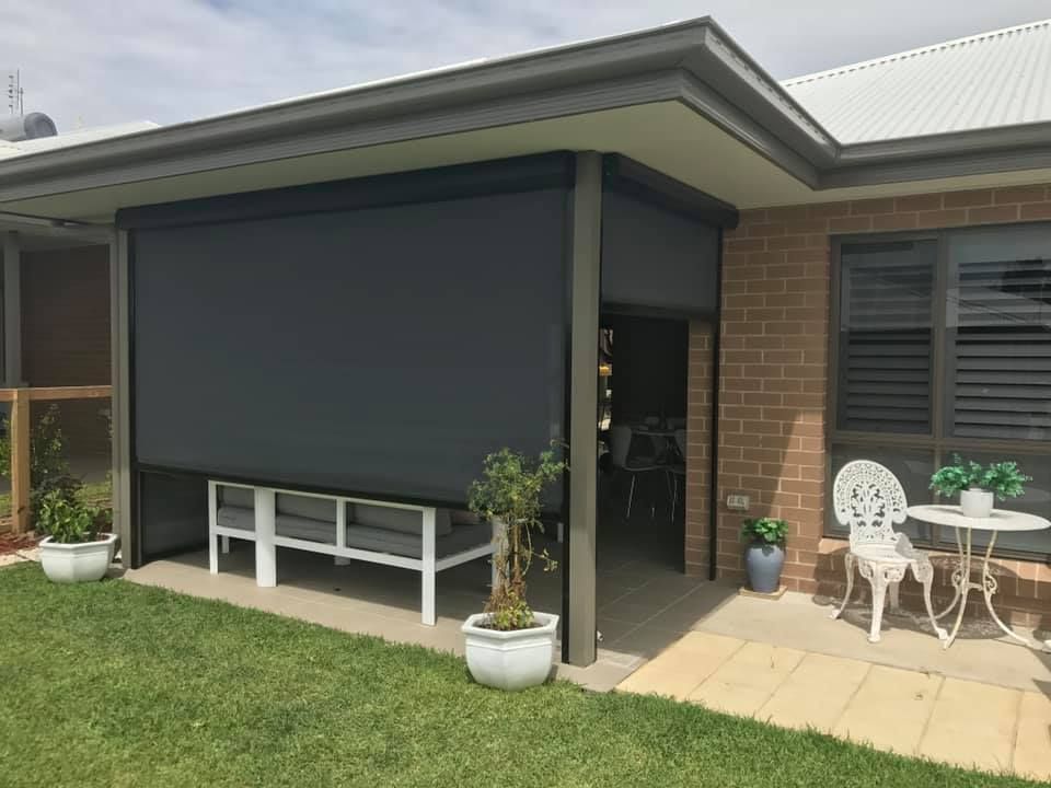 An Outdoor Area With An Awning, A Couch And A Coffee Table — Outdoor Blinds In Berkeley Vale, NSW