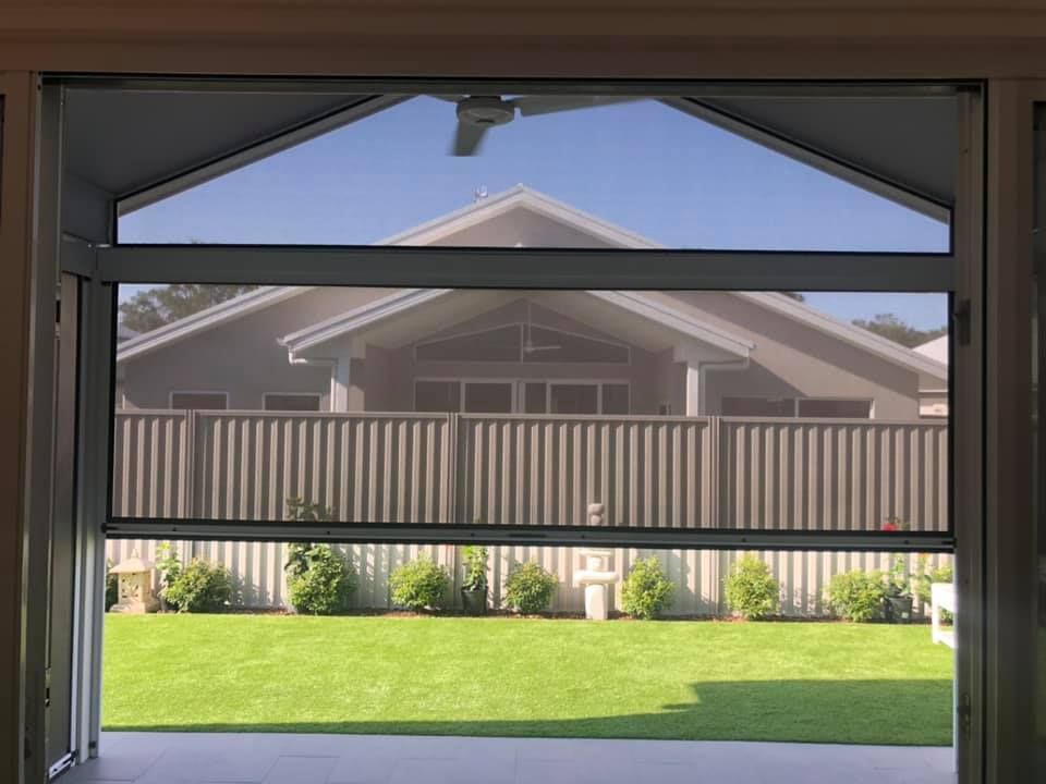 A View Of A House Through A Screen Door — Outdoor Blinds In Wyong, NSW
