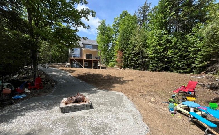 There is a fire pit in the middle of the yard.