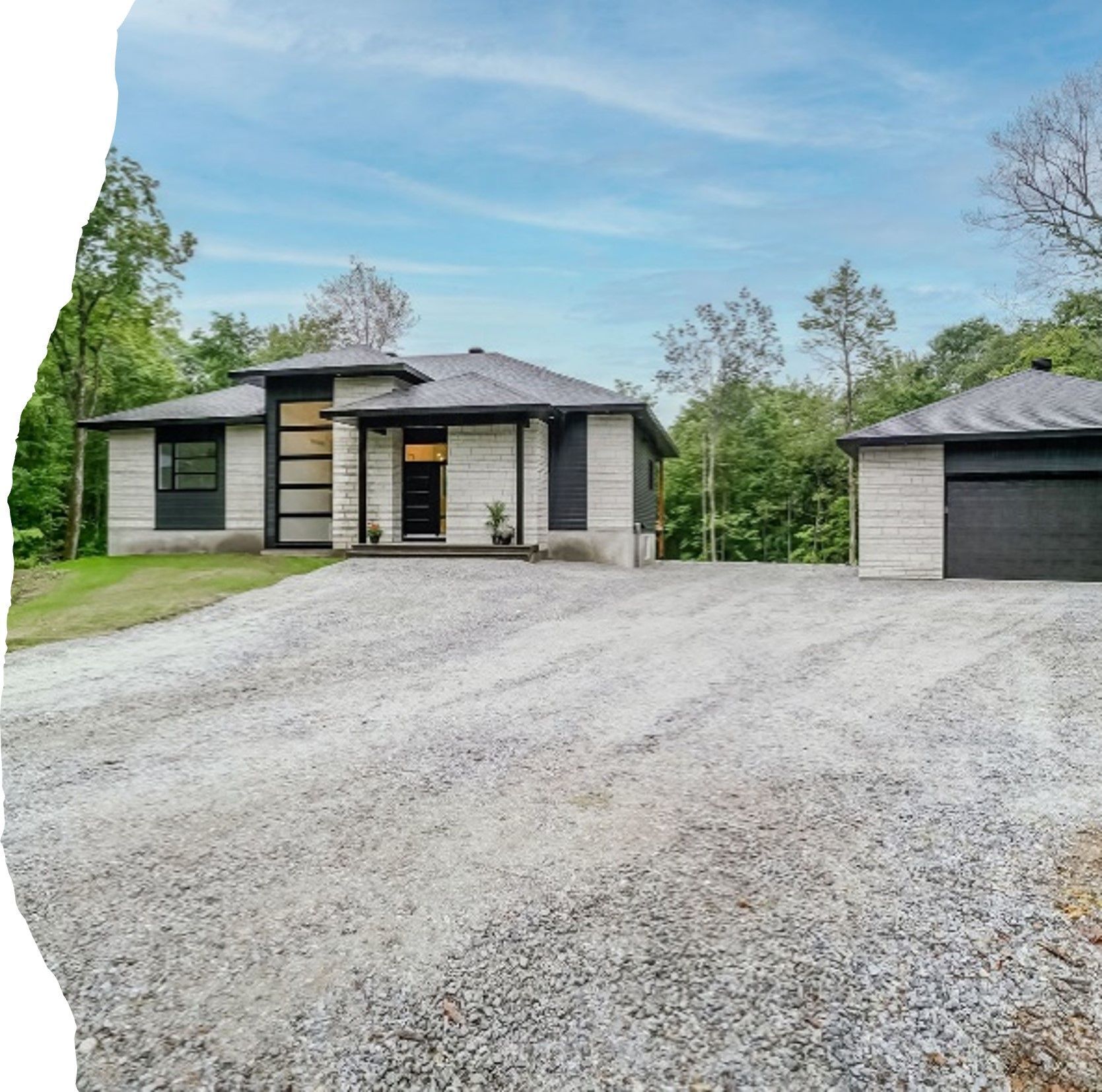 A house with a gravel driveway in front of it