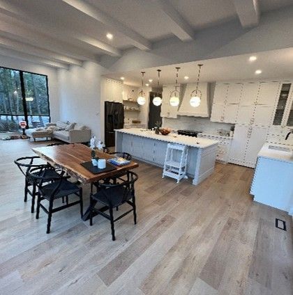 There is a dining table and chairs in the middle of the room.