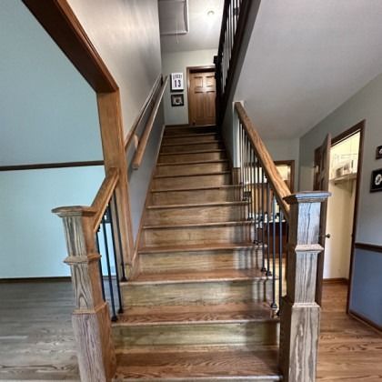 Wooden staircase in a home hallway with railings and hardwood floors