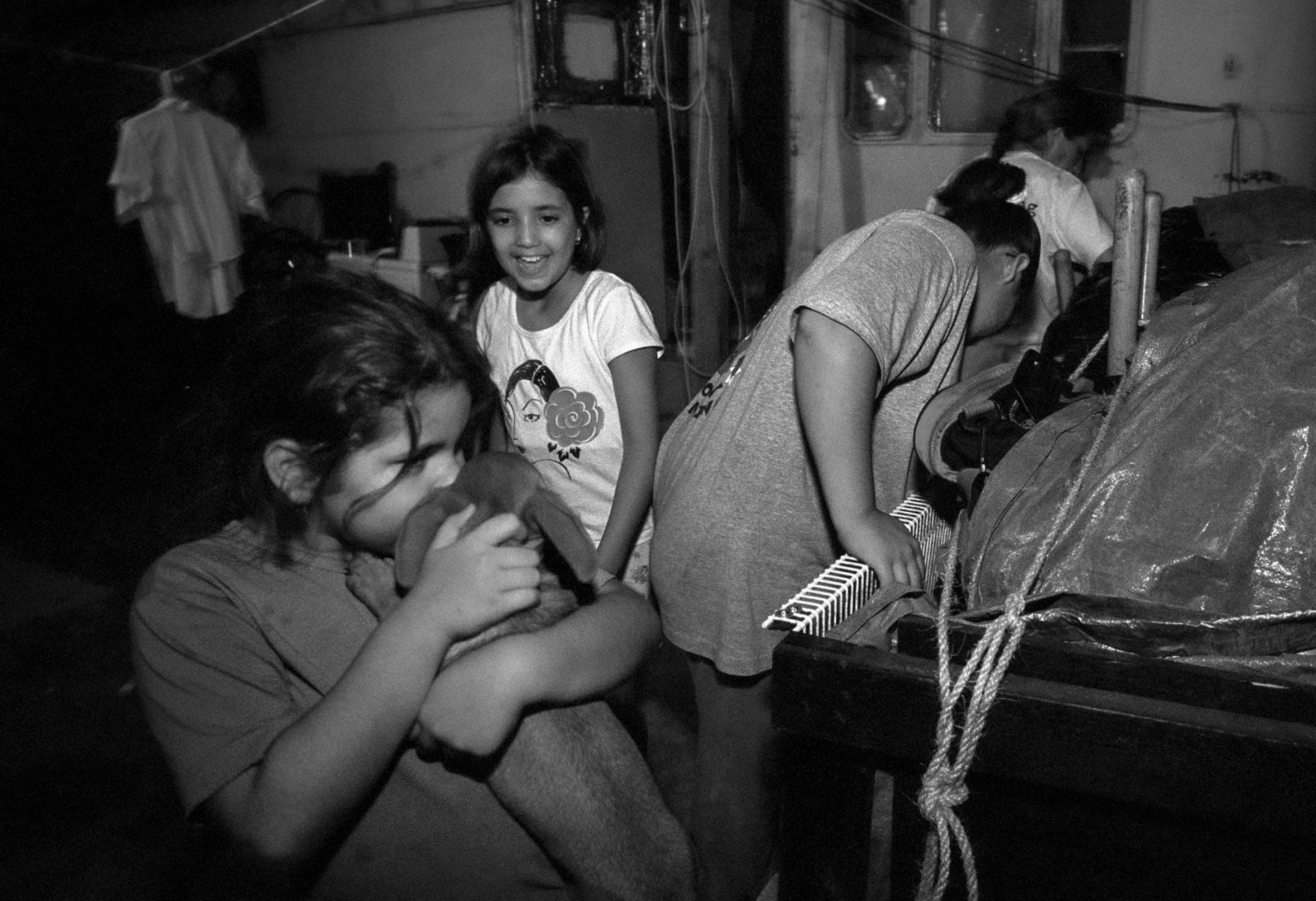 The girls say goodbye to their dog, Sassy, before heading out for the 14-hour drive to Kansas. They do not know how long they will be separated.