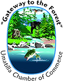 Umatilla Chamber of Commerce logo: forest scene with bear, eagle, leaping fish, and flowing water.