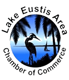 Lake Eustis Area Chamber of Commerce logo featuring a heron, palm trees, sailboat, and lake in a circular design.