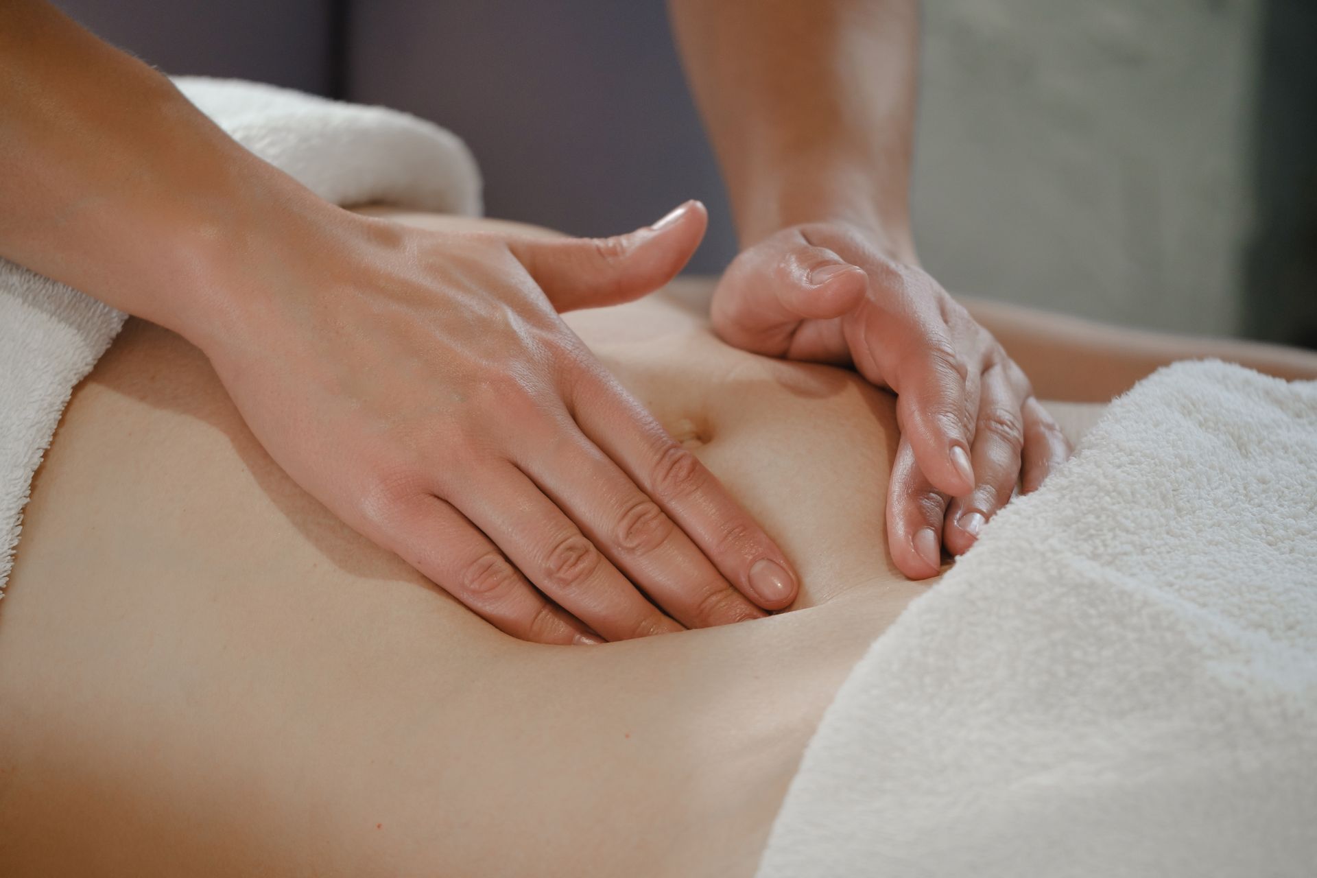 A woman is getting a massage on her stomach in a spa.