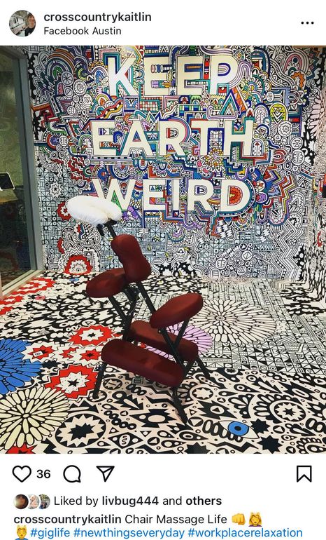 A massage chair is sitting in front of a wall that says `` keep earth weird ''.