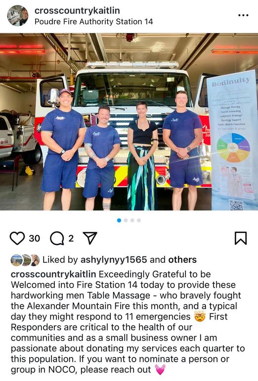 A group of people standing in front of a fire truck.