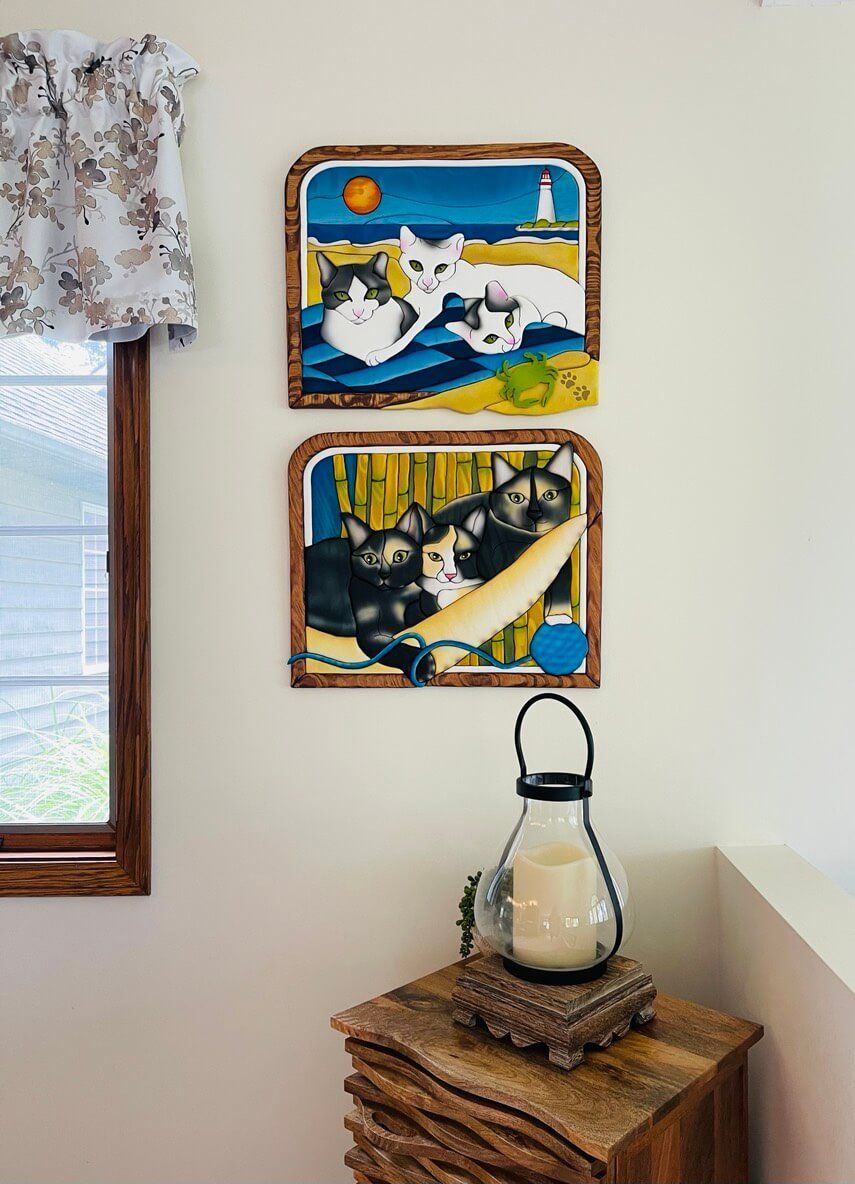 Intarsia art by Nick Vidakovic featuring two pieces with a trio of cats