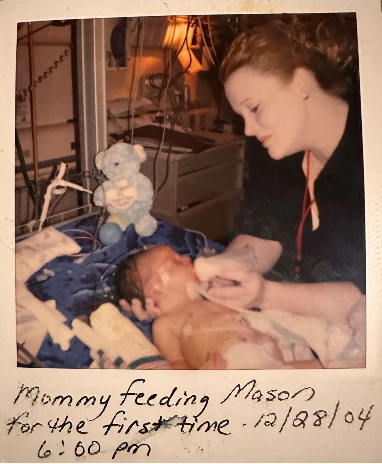 Woman leaning over newborn in hospital bassinet, 1984, with handwritten note below.