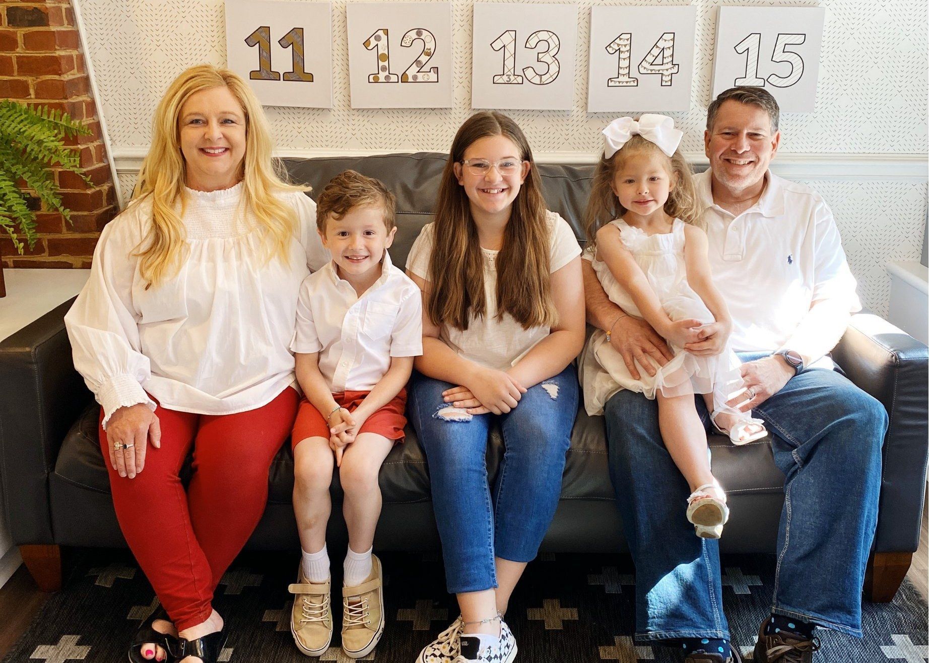 The Runyon family smiling together on a bench at Ronald McDonald House Greater Chattanooga.