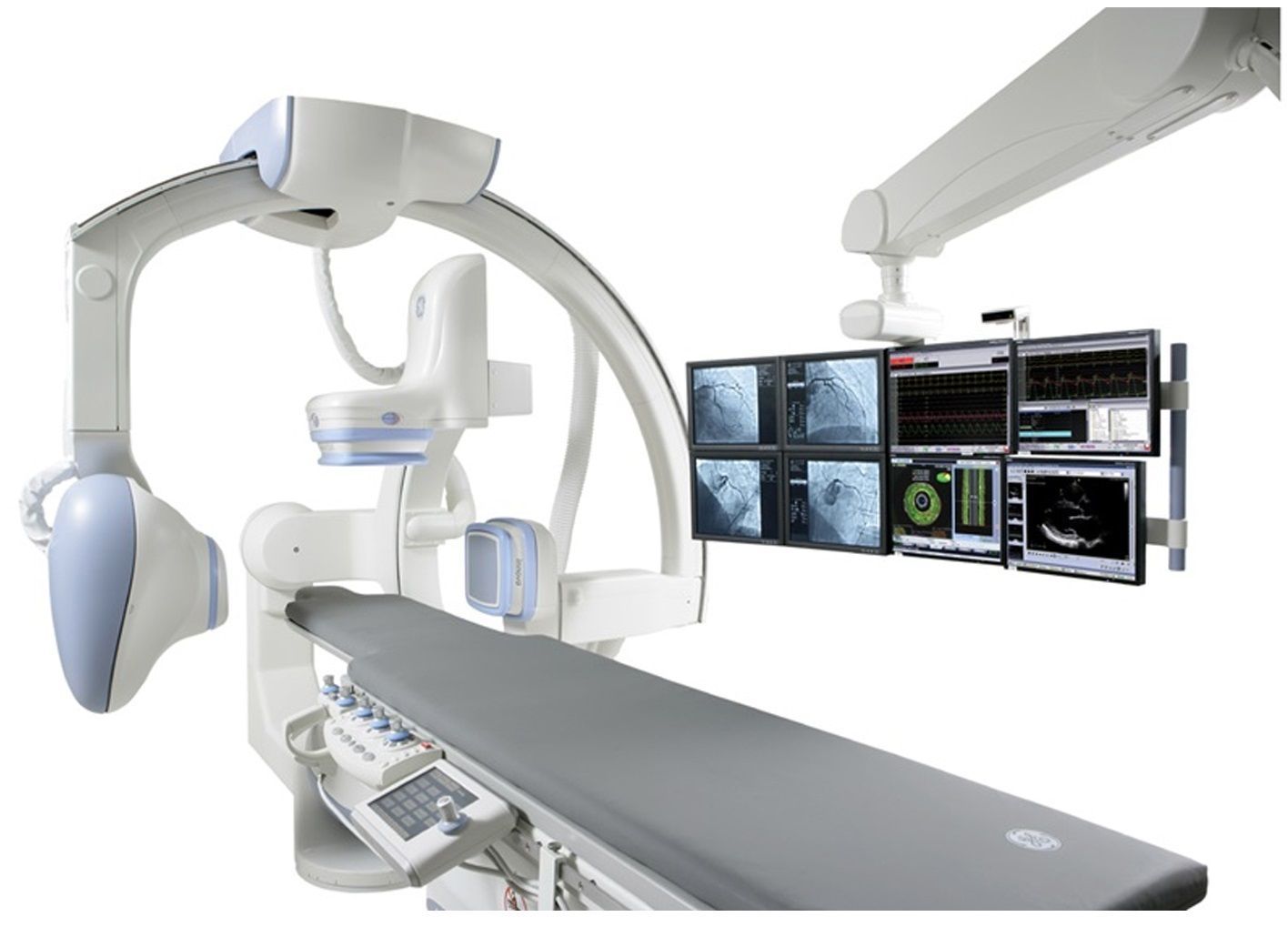 Medical imaging system with multiple monitors and an examination table.