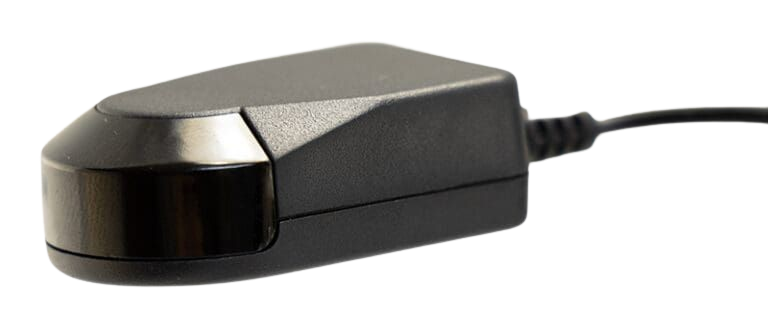 Black rectangular device with curved front, attached to a black cord.