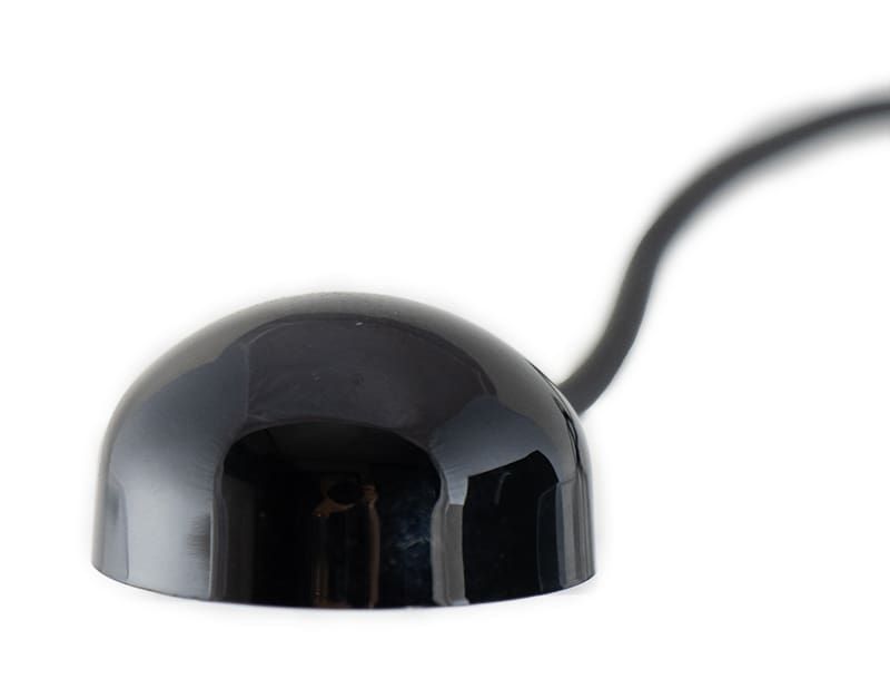 Black dome-shaped infrared receiver with a black cable extending from it, against a white background.