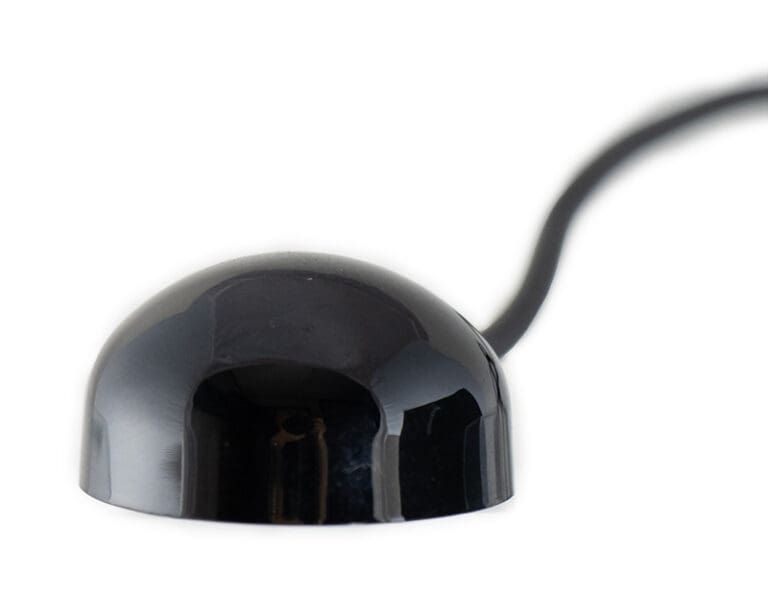 Black domed IR receiver with a cable extending from the back against a white background.