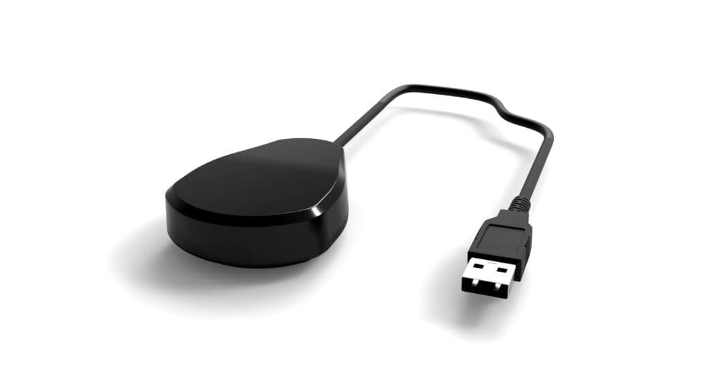 Black electronic device with attached USB cable on white background.