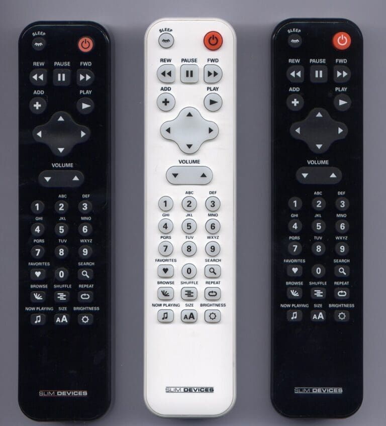 Three remote controls: two black and one white. All have similar buttons, red power, and volume controls.