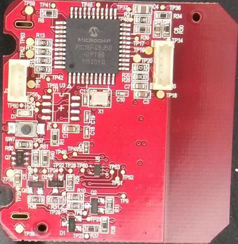 Red circuit board with Microchip processor, various components, and test points.