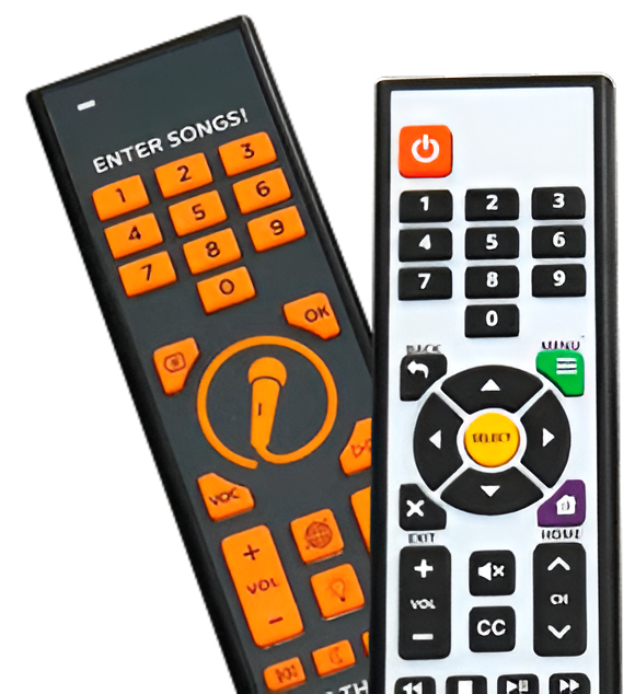 Two karaoke machine remotes: black with orange buttons and white with color buttons.