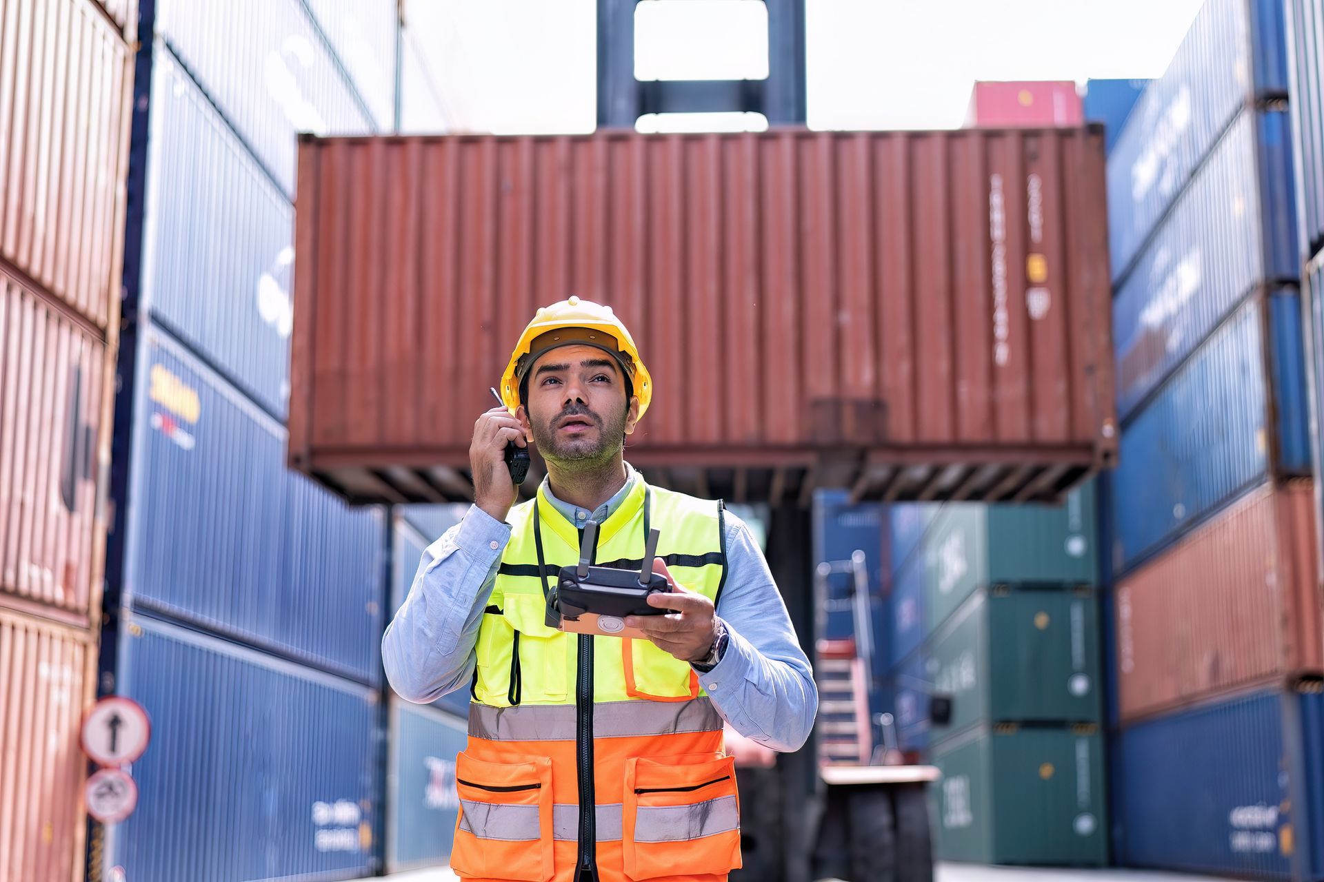 Industrial worker conducting safety evaluation of shipping containers for business use