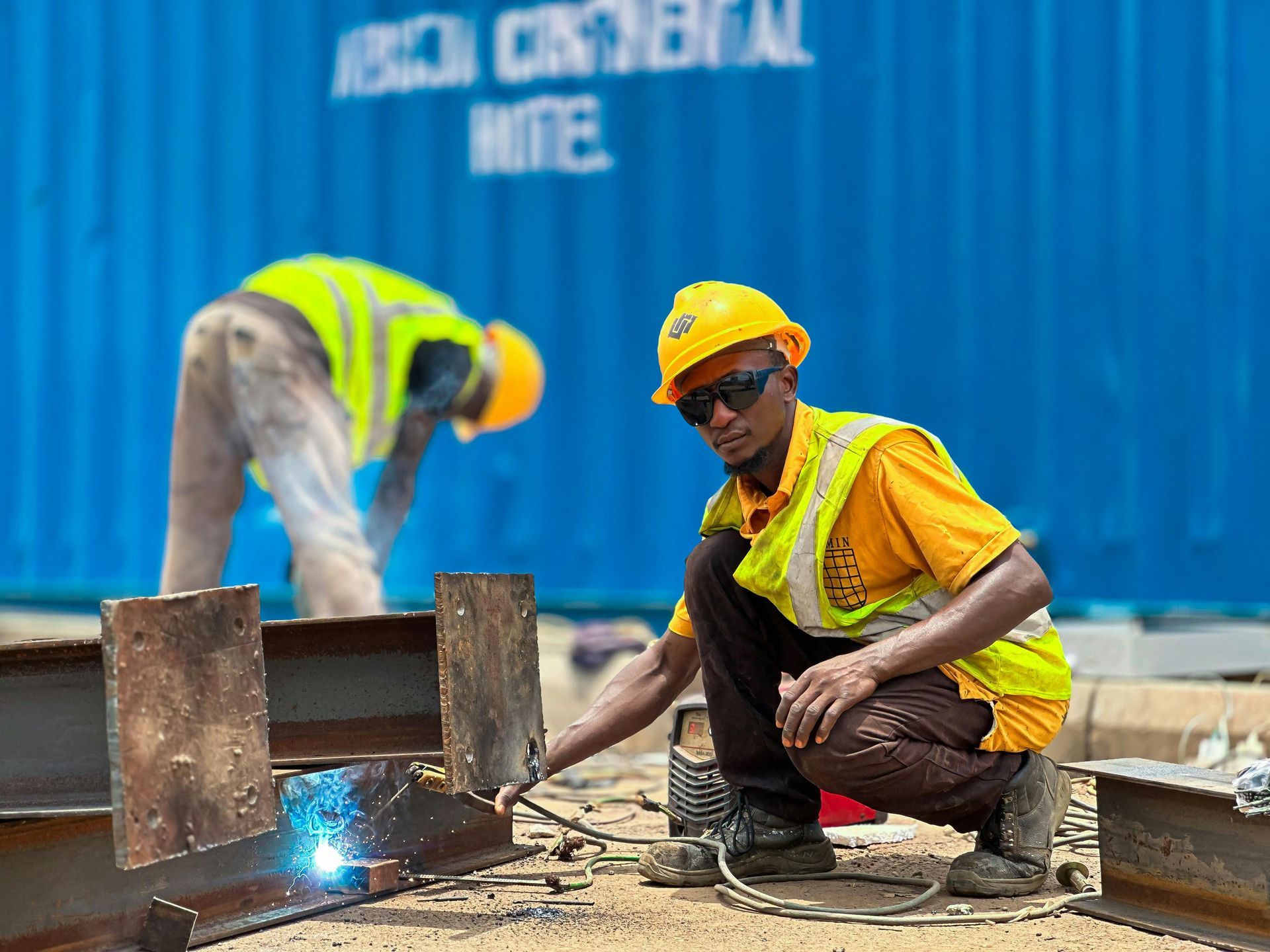 Construction site workers with steel storage containers for secure equipment storage