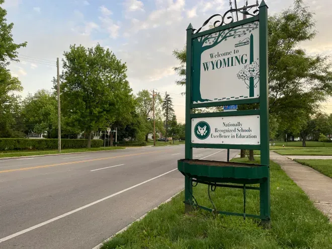Welcome to Wyoming, Ohio community sign surrounded by greenery.