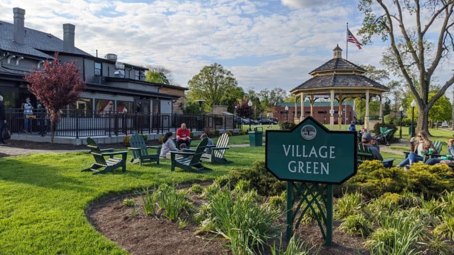 Village Green park in Wyoming, Ohio with gazebo, lawn chairs, and community gathering space on a sunny day.
