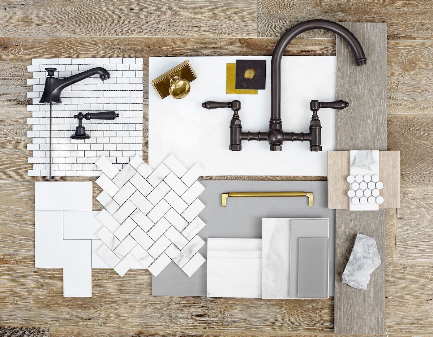 A flat-lay design board featuring kitchen fixtures, white marble tile patterns, grey paint samples, and gold hardware.
