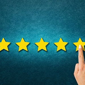 A hand selecting the fifth yellow star in a row of five on a textured teal background.