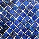 A pattern of small, square blue glass tiles with varying shades and swirled textures, set in a grid at a diagonal angle.
