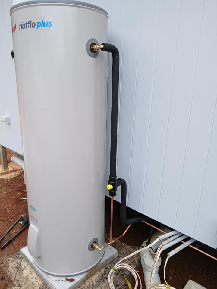 A Beige Thermann Electric Hot Water Heater Tank Stands — APD Plumbing In Beechwood, NSW