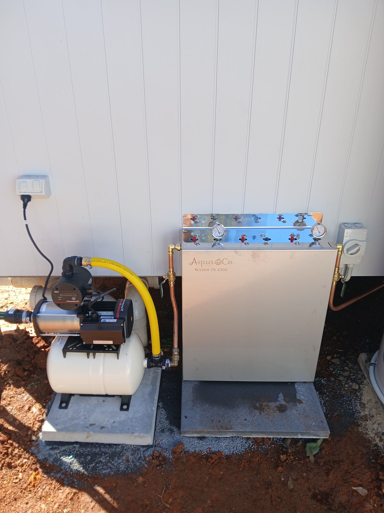 An Electric Water Pump Connected to a Metal Filtration Unit — APD Plumbing In Beechwood, NSW