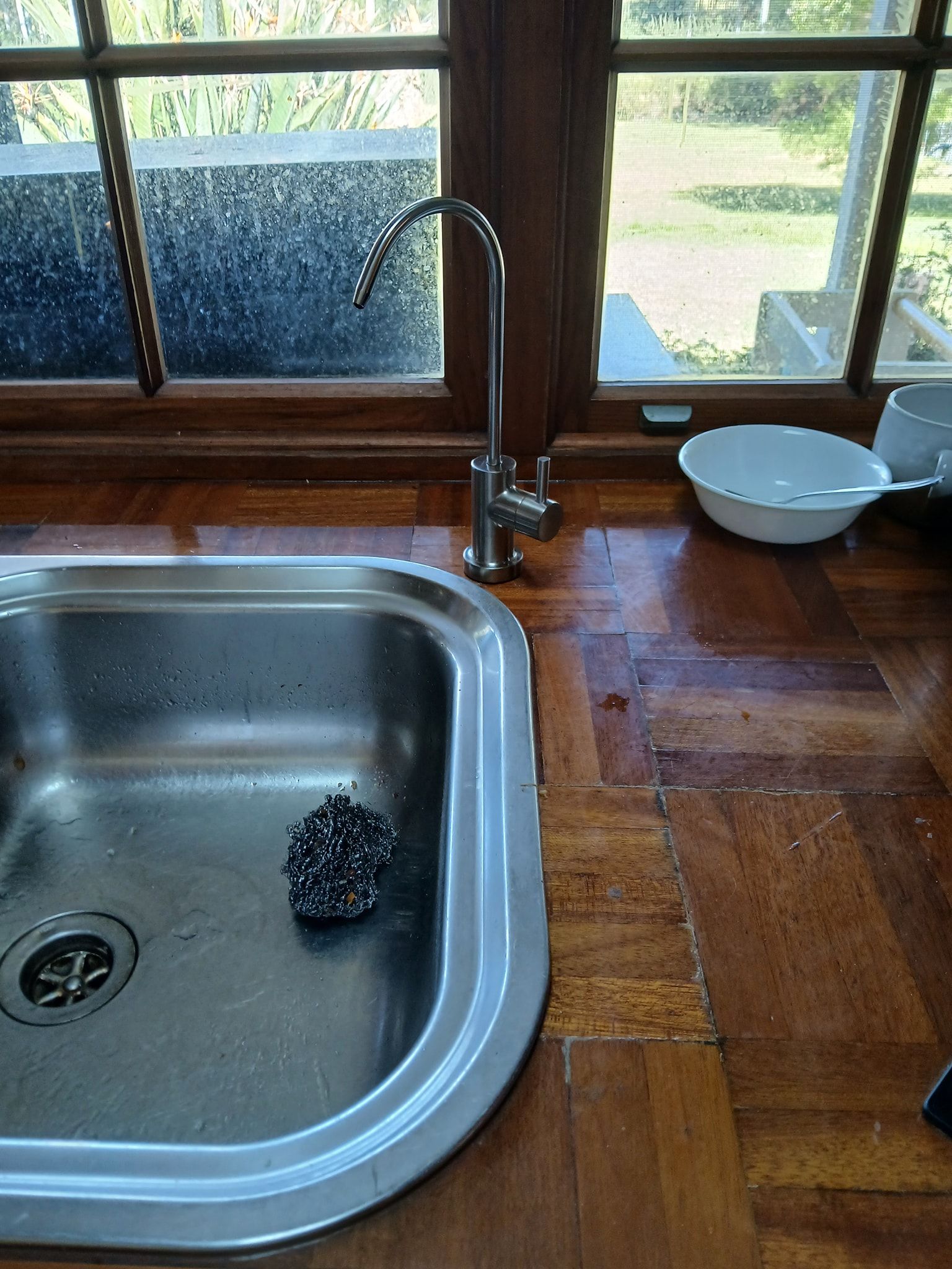 A Stainless Steel Sink With a Scrub Pad — APD Plumbing In Forster, NSW