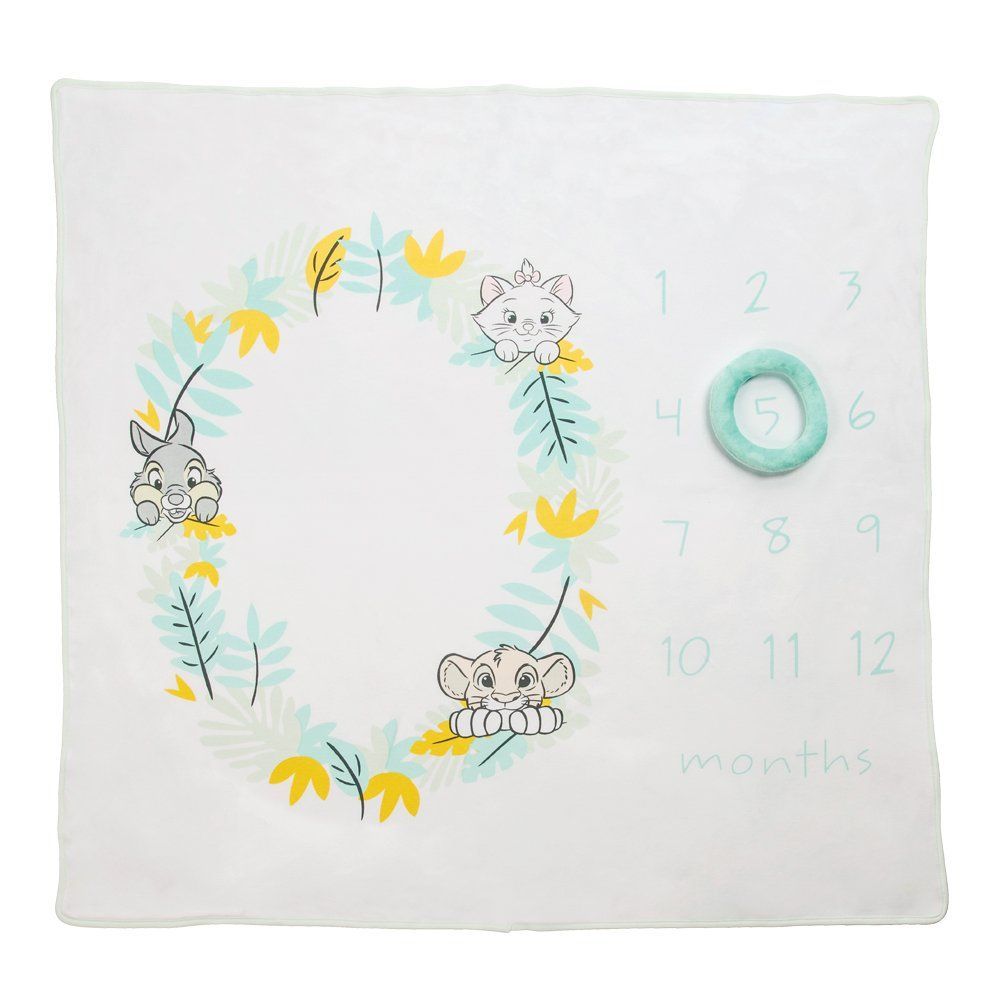 Witte babydeken met mijlpaalafbeeldingen, dierenillustraties, de maanden in cijfers en een ring.