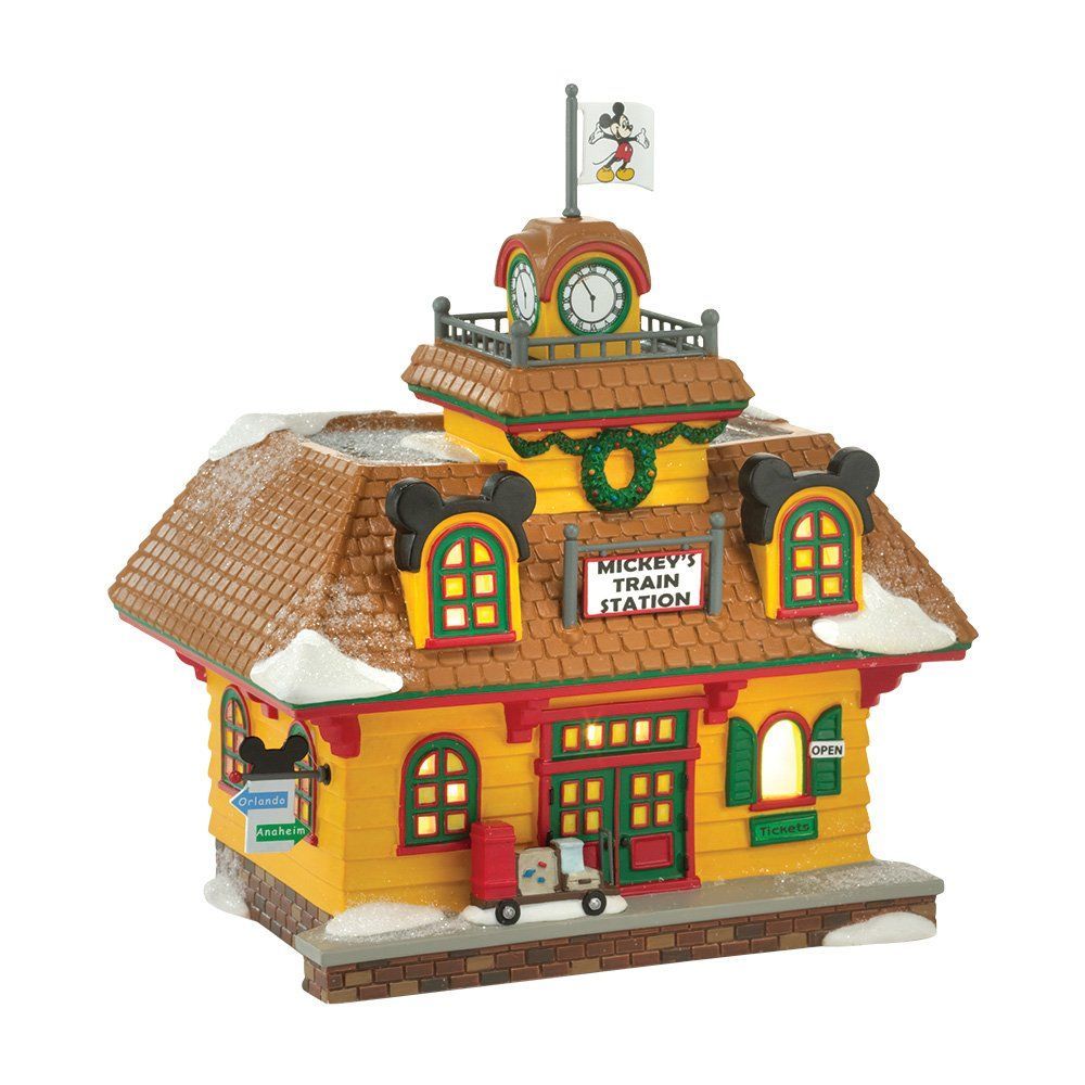 Disney's Mickey Train Station-figuurtje. Geel gebouw met Mickey-oren, klokkentoren en kerstkrans. Mickey-vlag bovenop.