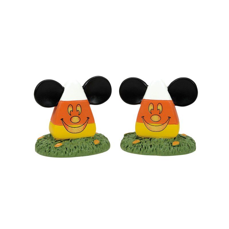 Twee Halloween-snoepmaïsfiguurtjes met Mickey Mouse-oren in het gras.