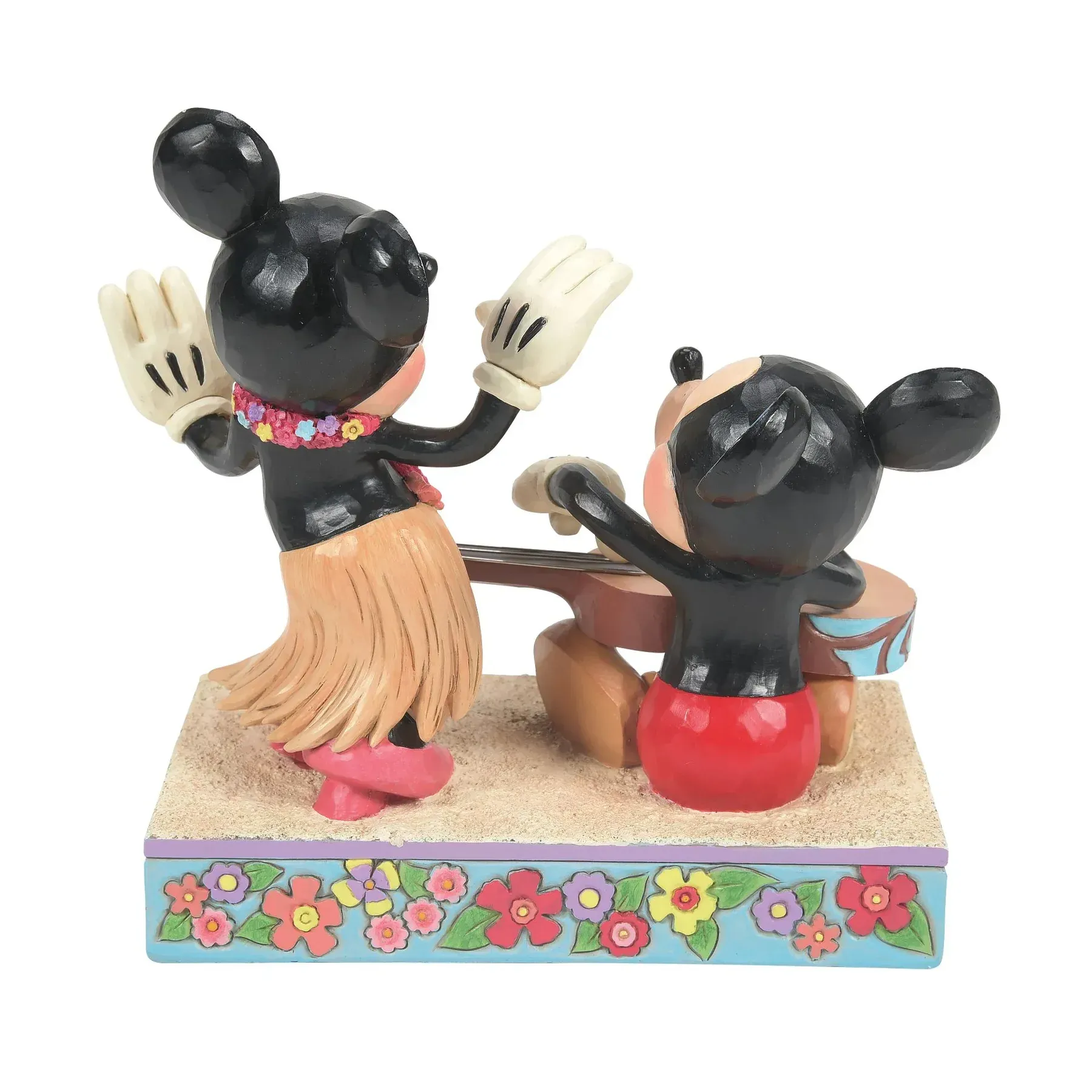 Mickey Mouse speelt ukelele, Minnie danst in een hula-rokje op een zanderig podium, beiden met geruite oren.