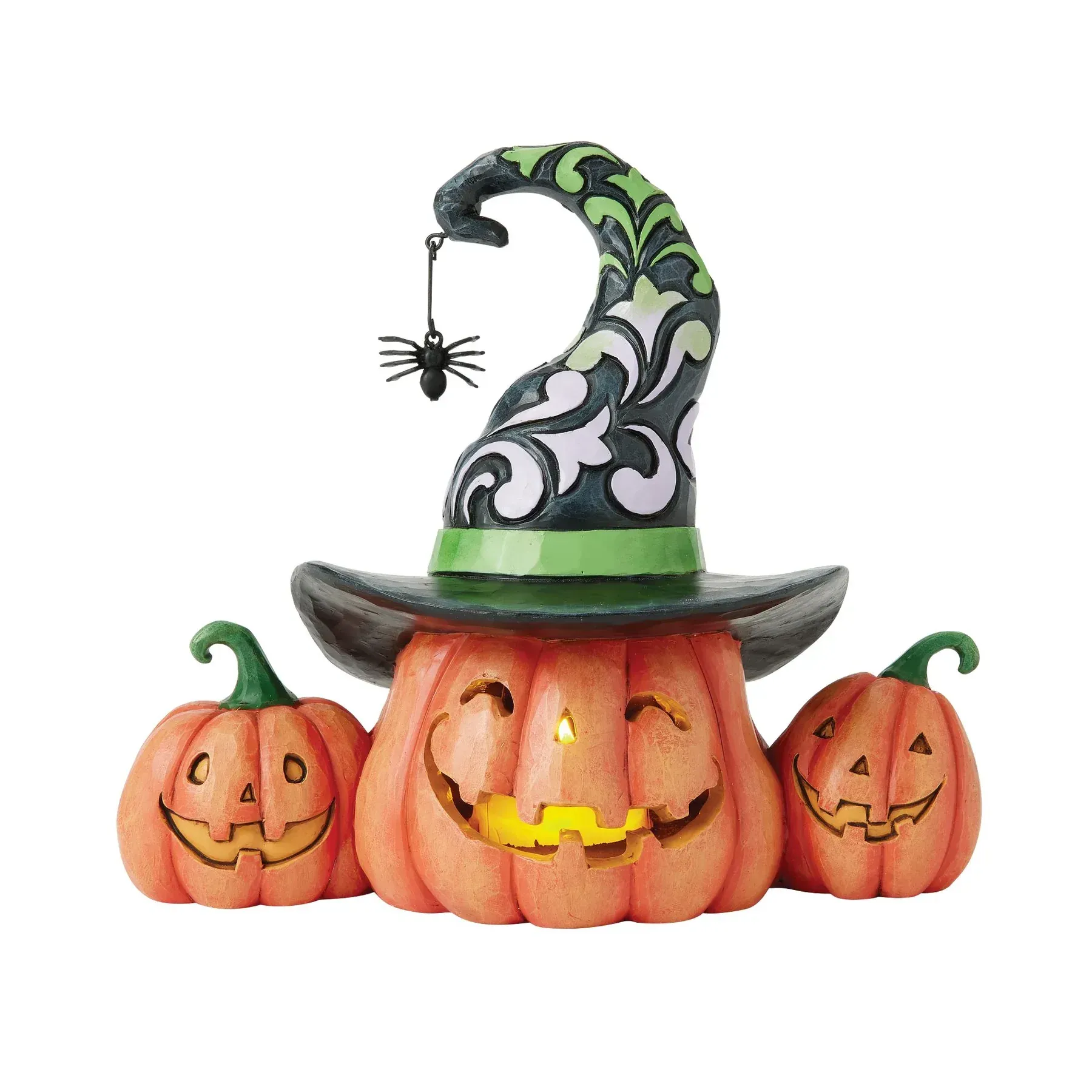 Halloweenpompoenversiering met heksenhoed en lachende gezichtjes.