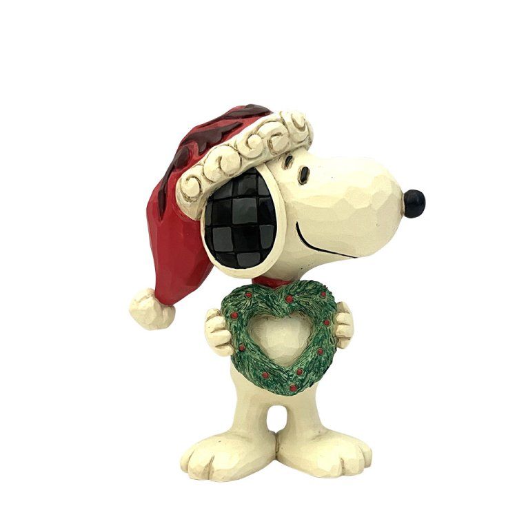 Snoopy met een rood-zwart geruite kerstmuts op en een hartvormige kerstkrans in zijn handen.