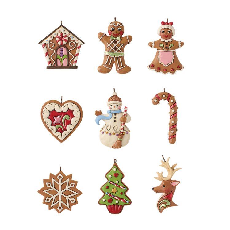 Negen kerstversieringen van peperkoek: een huis, mensen, een hart, een sneeuwpop, een zuurstok, een sneeuwvlok, een boom en een rendier.